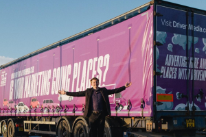 Dragon's Den Winner Ed Holland stands in front of a fully wrapped branded truck